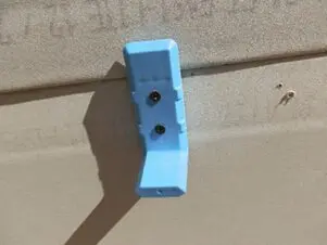 Light blue bracket on beige wall