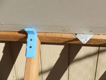 Blue bracket on wooden structure
