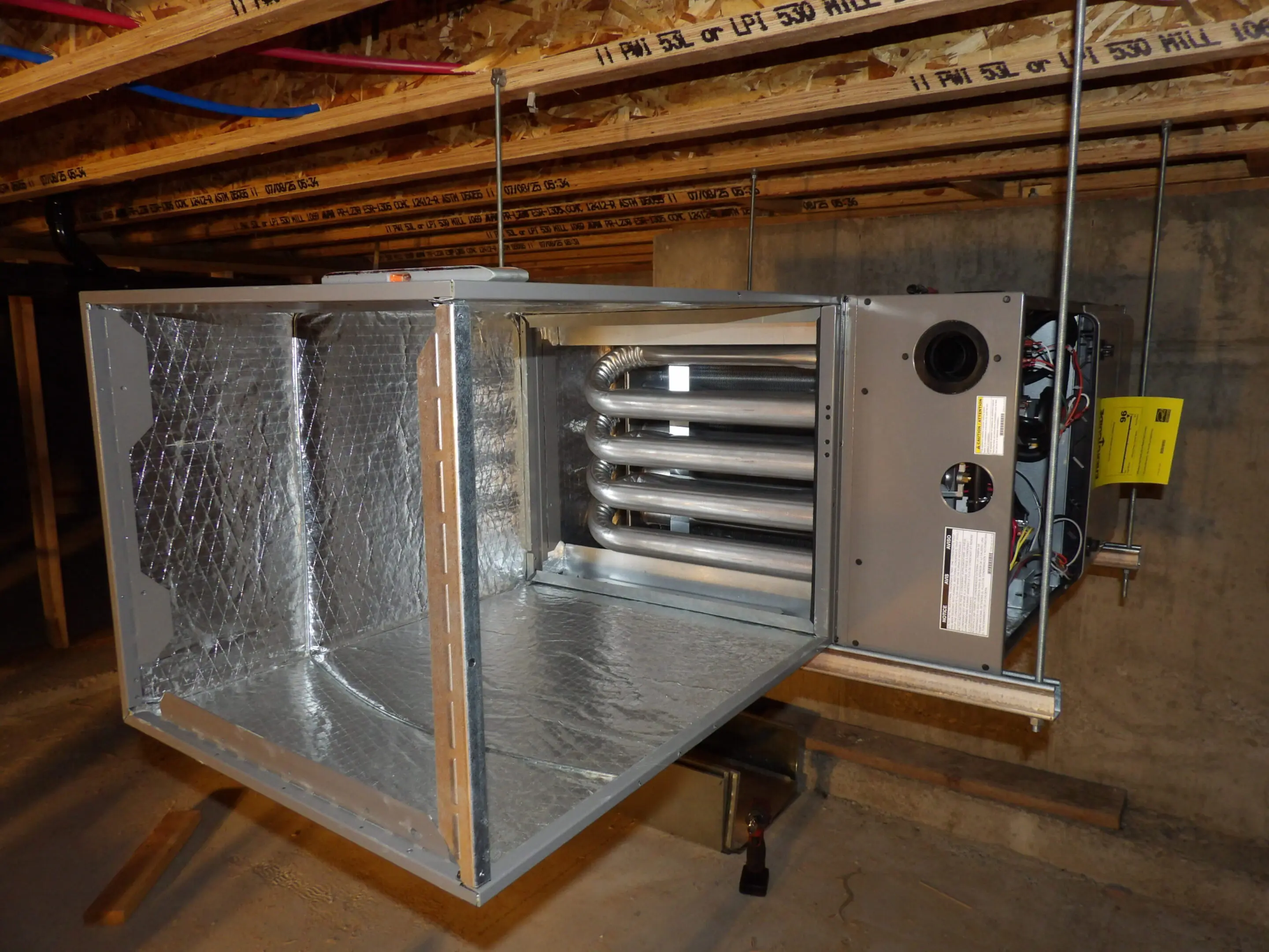Open attic HVAC duct with air handler unit.