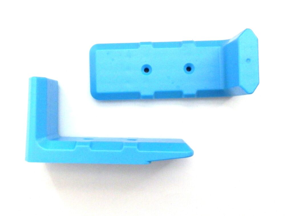 A pair of blue plastic pieces sitting on top of a table.
