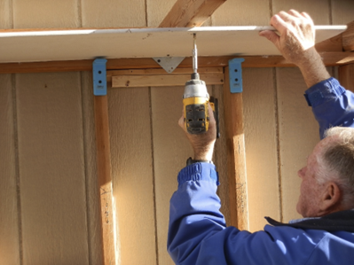 A blue handle is attached to the side of a wall.